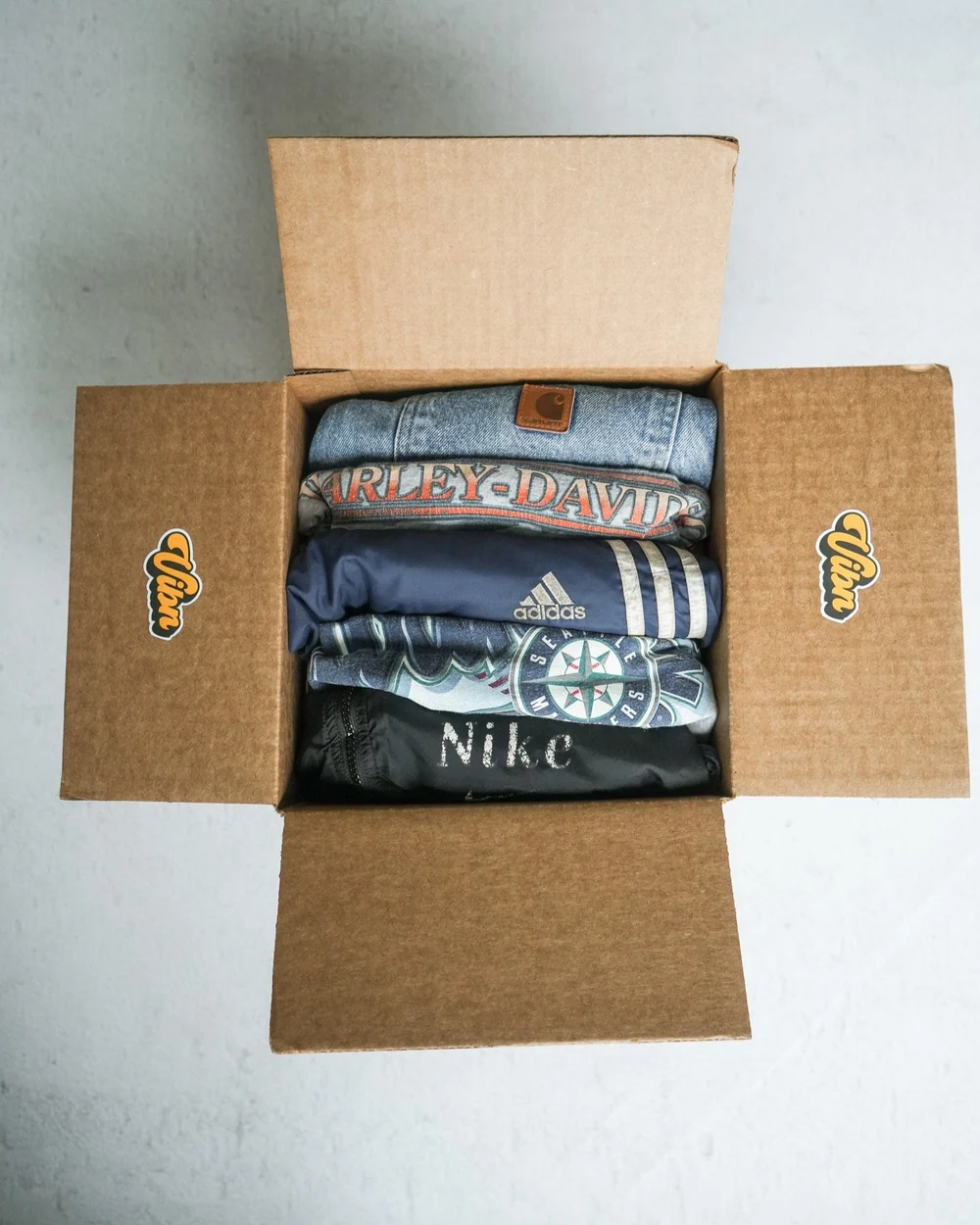An open mystery box with curated vintage clothing